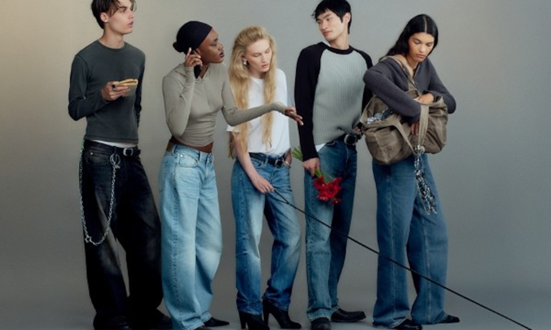 Models laying on the beach wearing parts of the 2025 Weekday collection