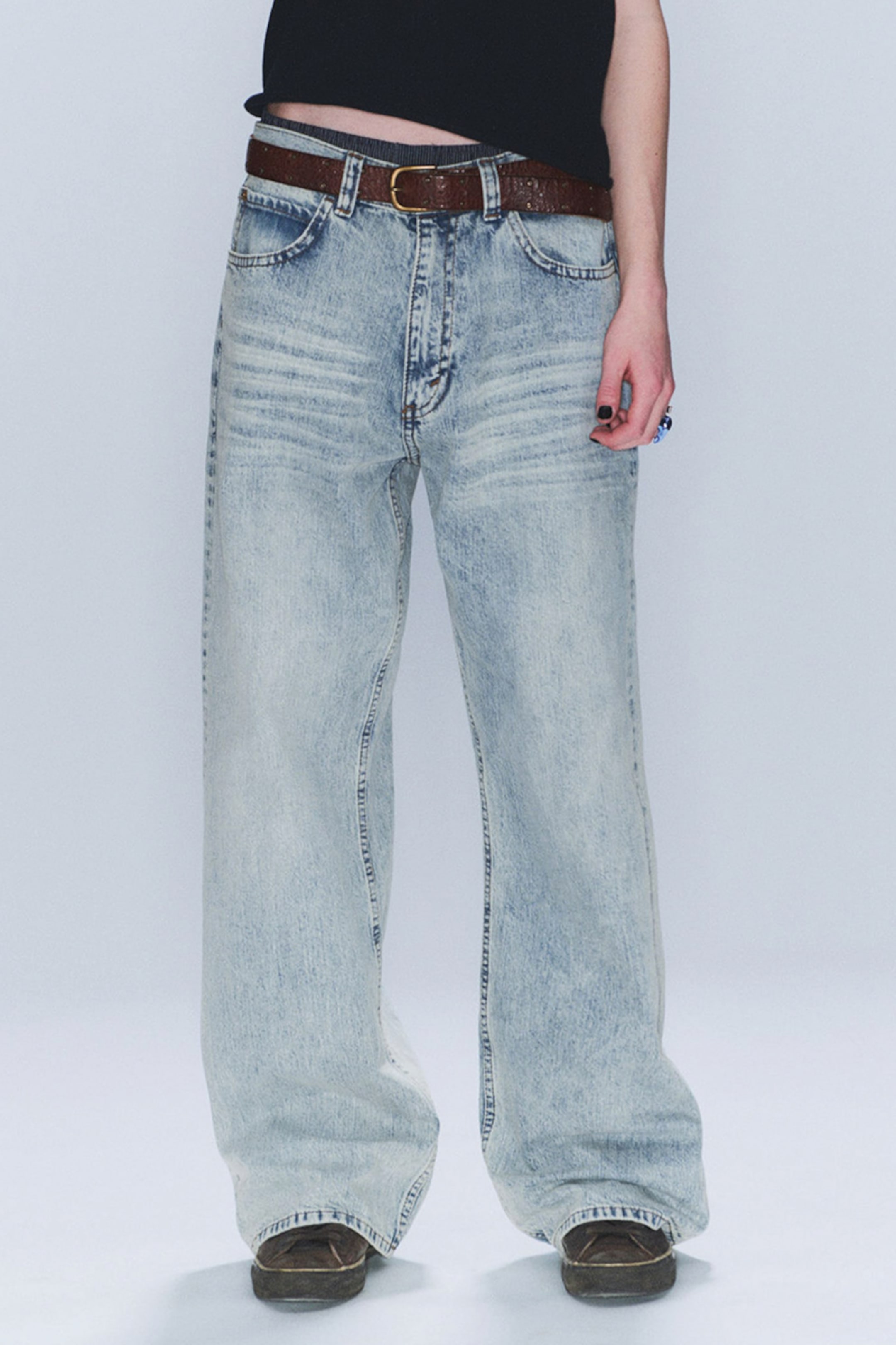 Model wearing a pair of looser cheap monday jeans