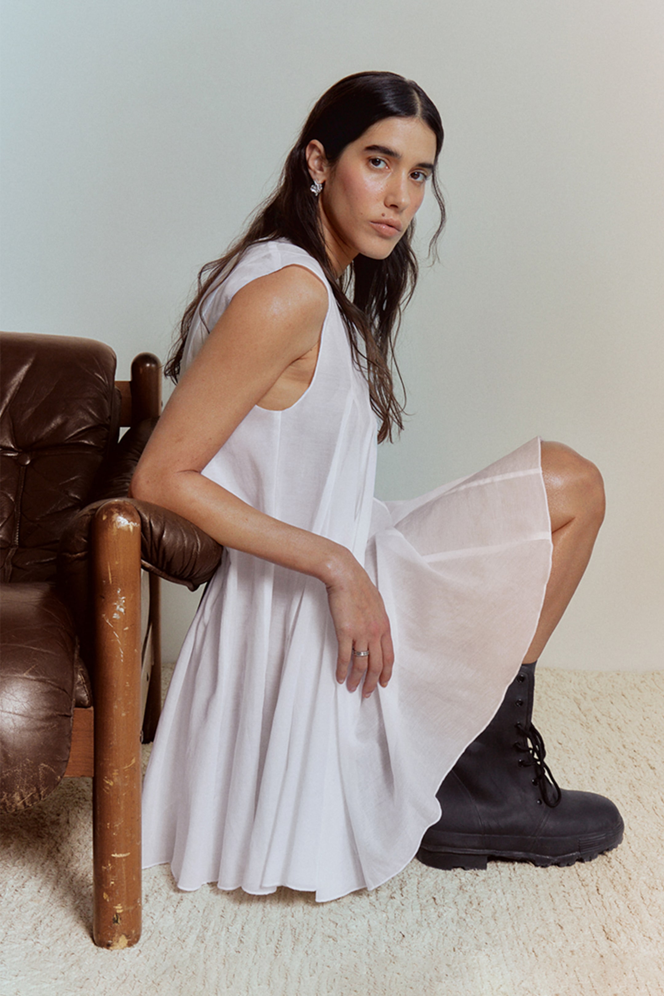 A woman wearing an outfit from the Weekday collection 2025