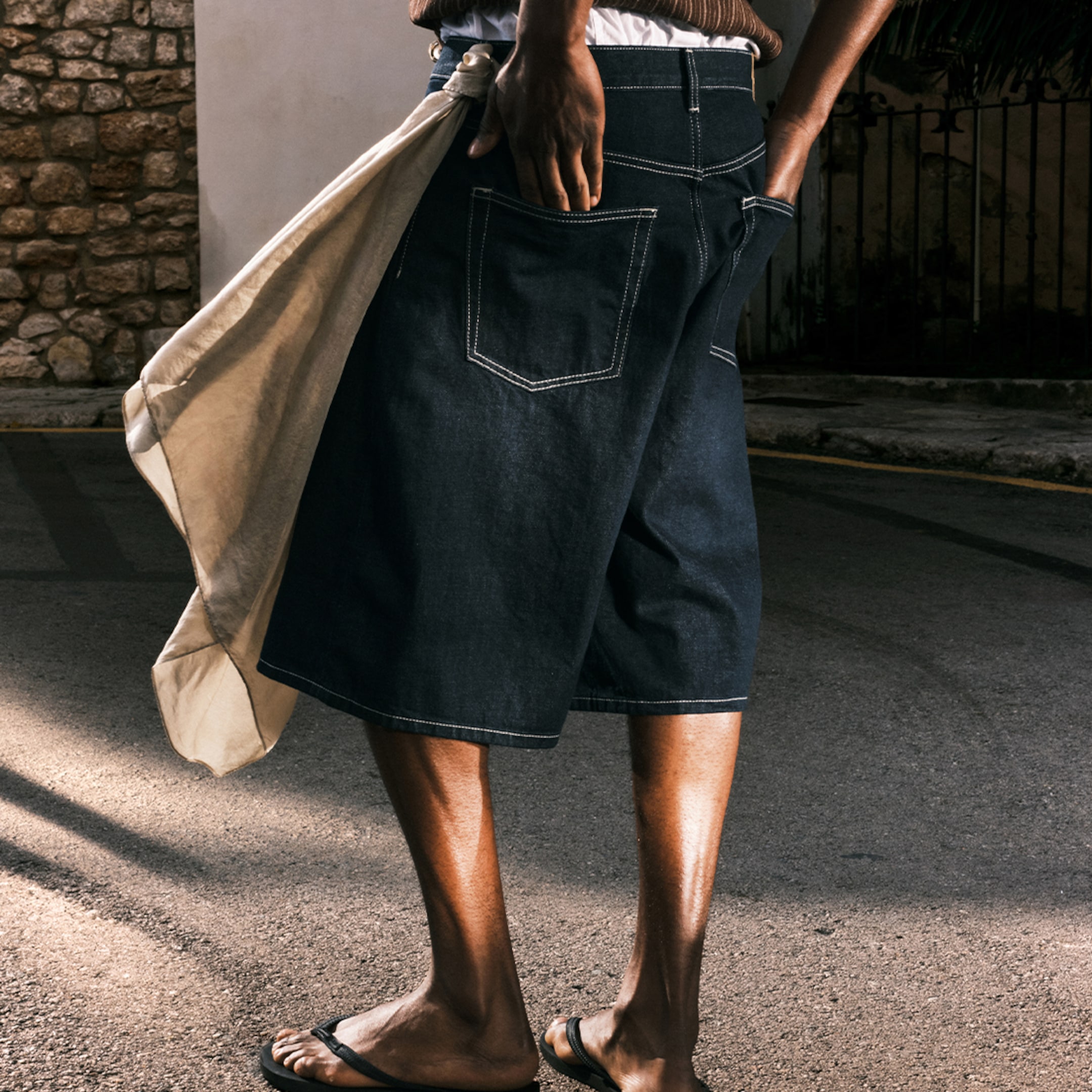 Model wearing a pair of blue rinse Astro Baggy Shorts