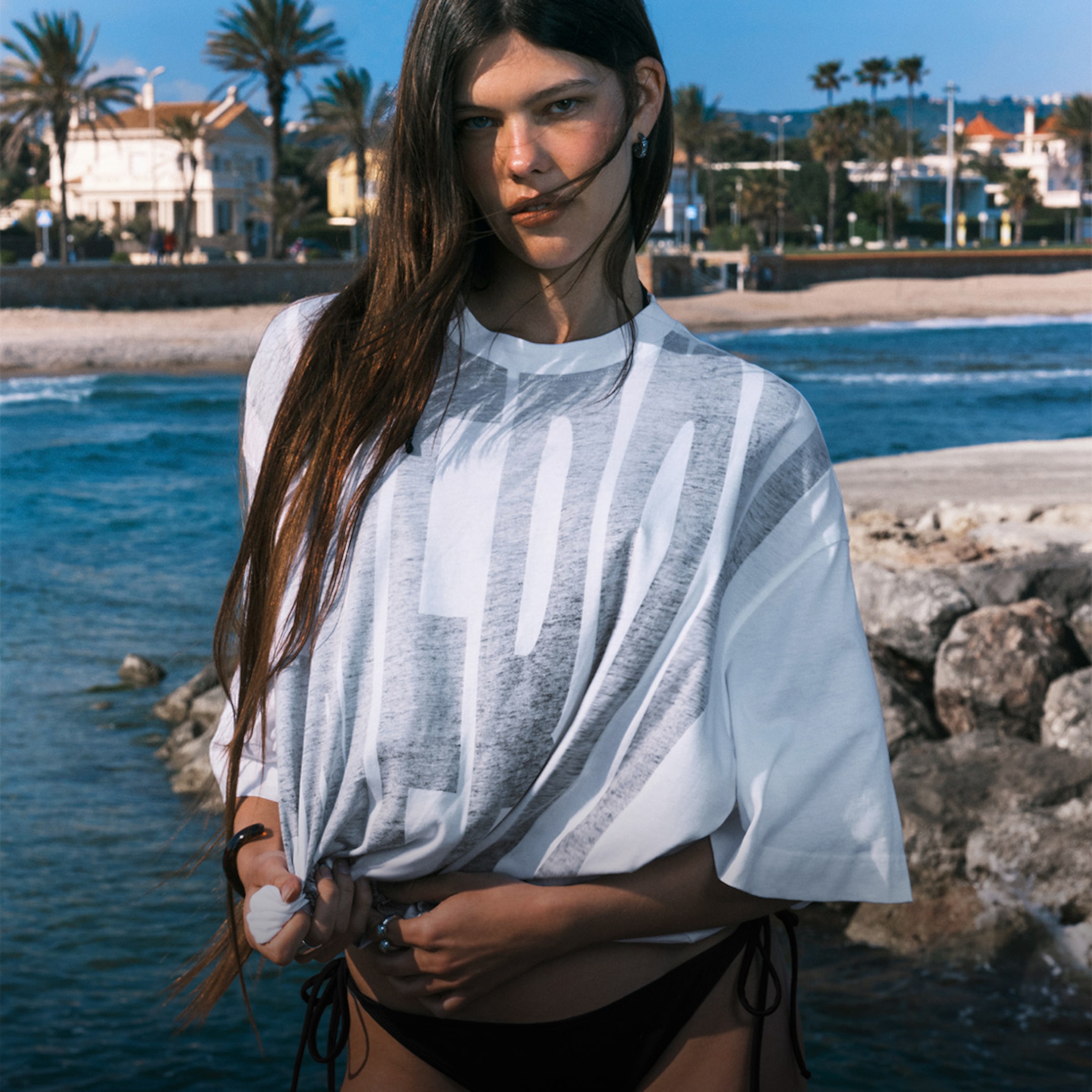 A woman wearing white t-shirt and bikini