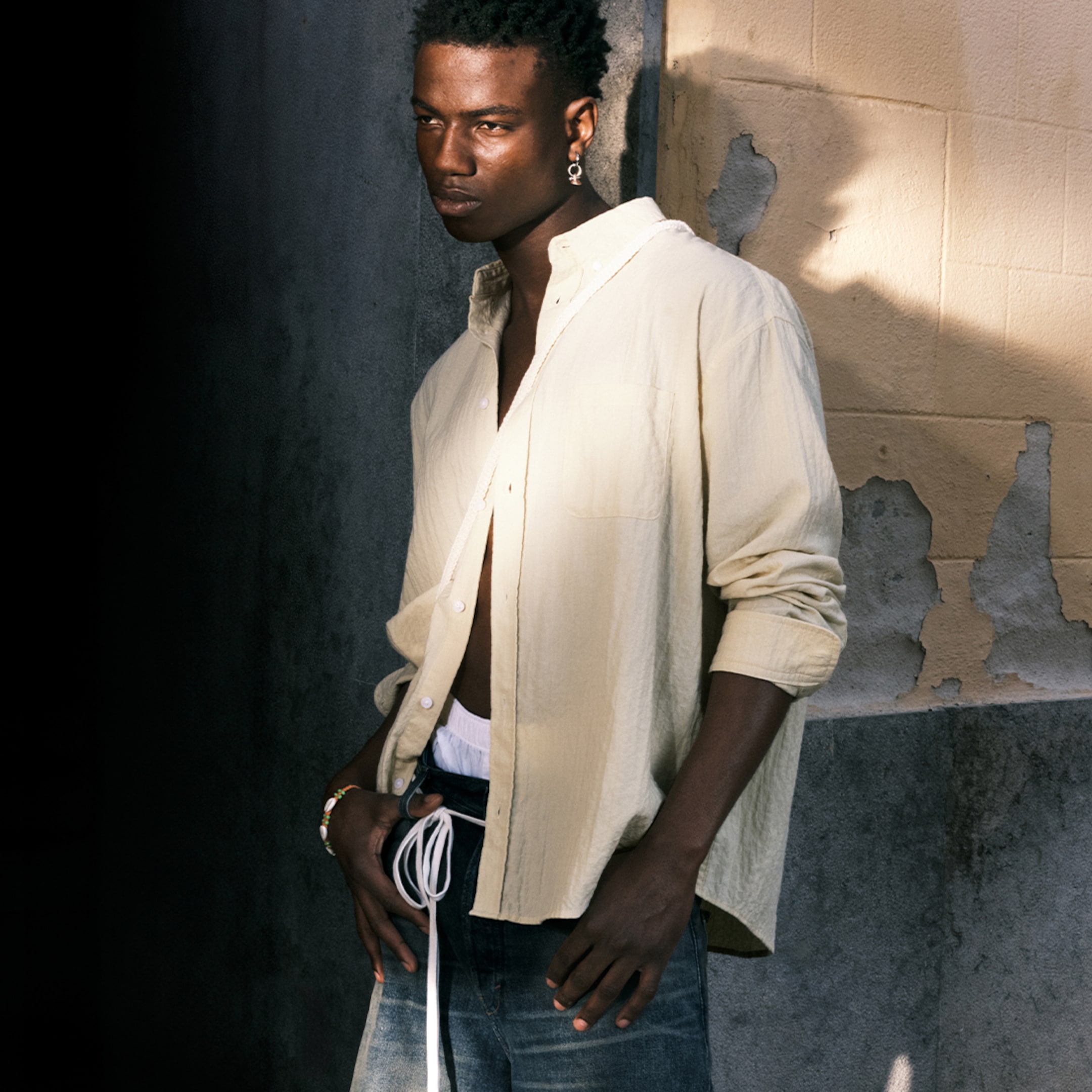 Model wearing a light yellow seersucker shirt paired with a pair of Weekday Jorts