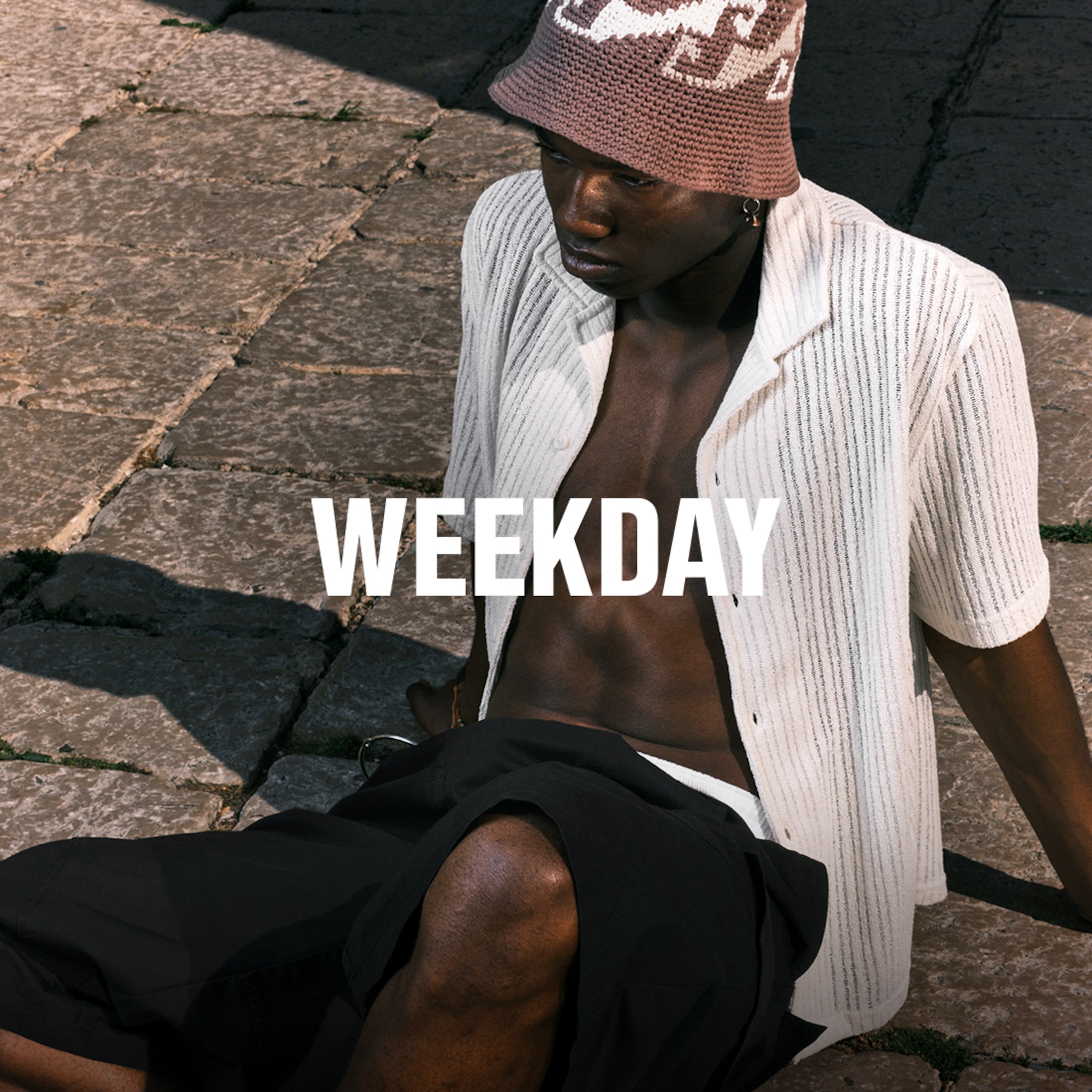 Model wearing a shirts and a pair of jorts from the Weekday 2025 collection