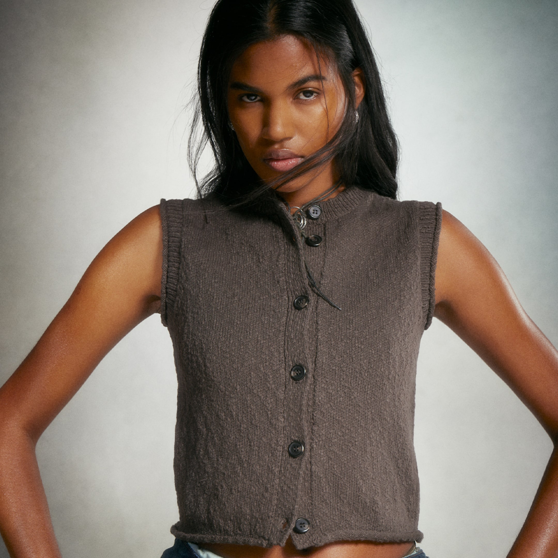 Model wearing a knitted sweater vest