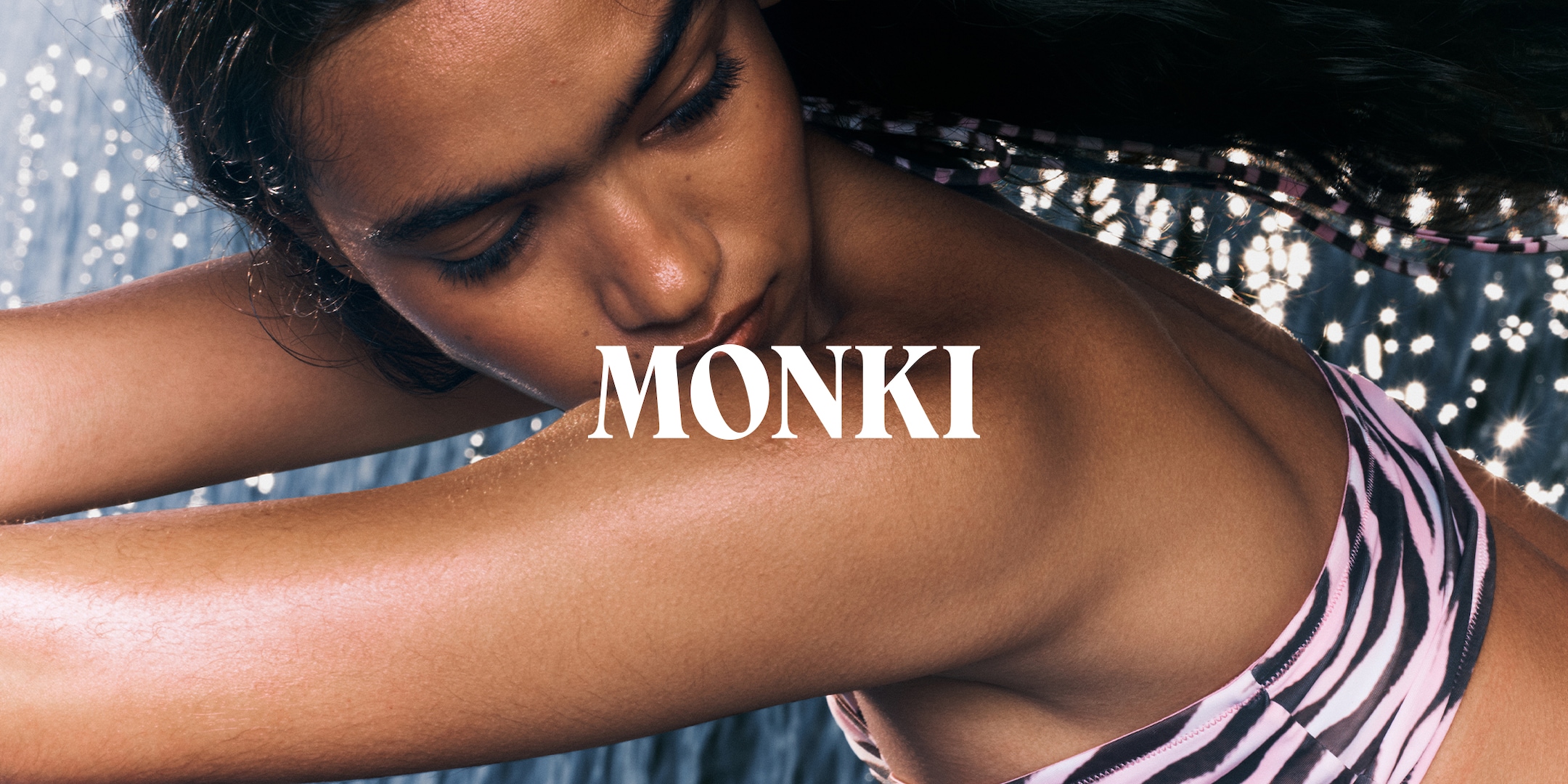 Model wearing Monki swimwear and the brand logo is inbedded on the image