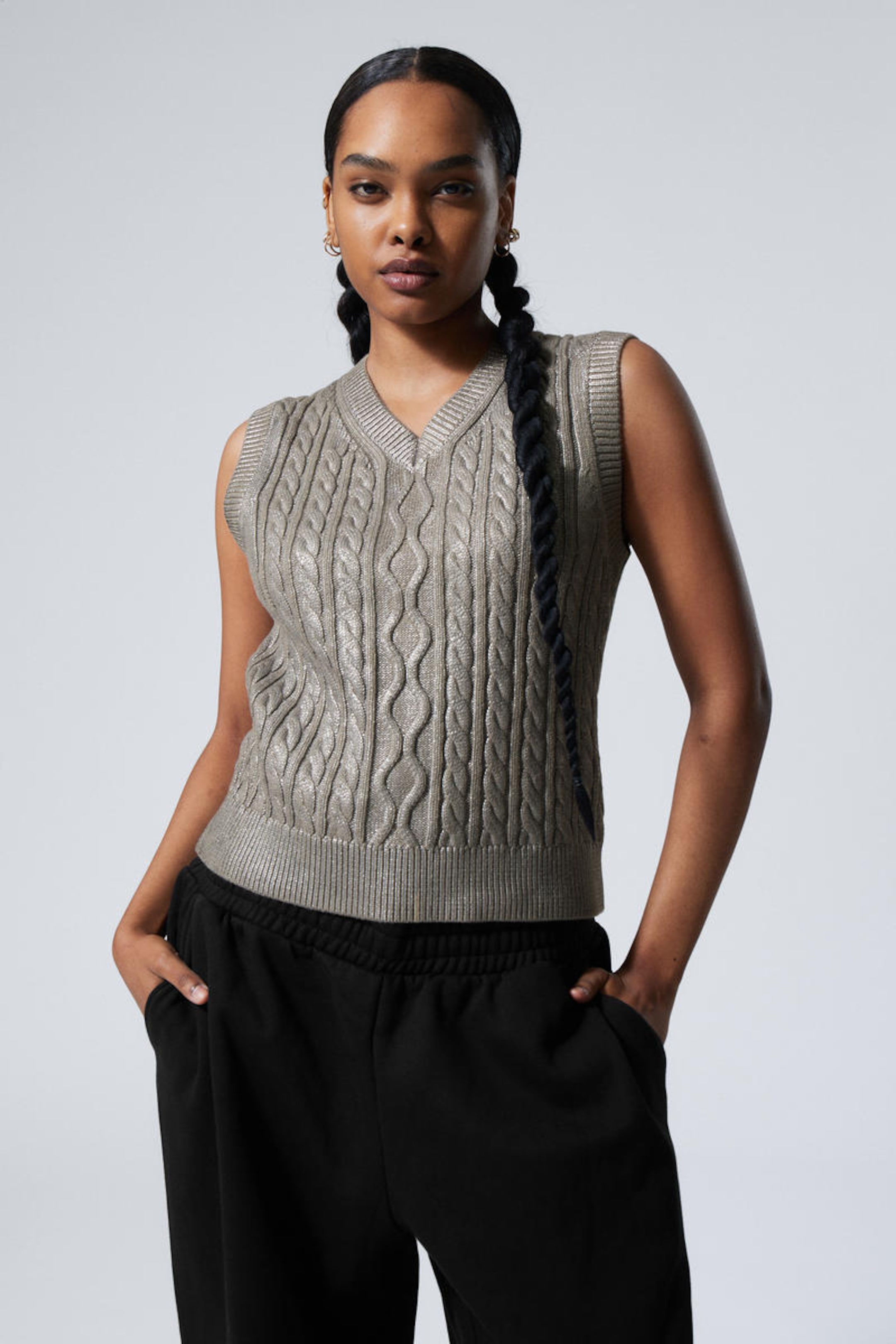 A woman wearing metallic cable-knitted vest